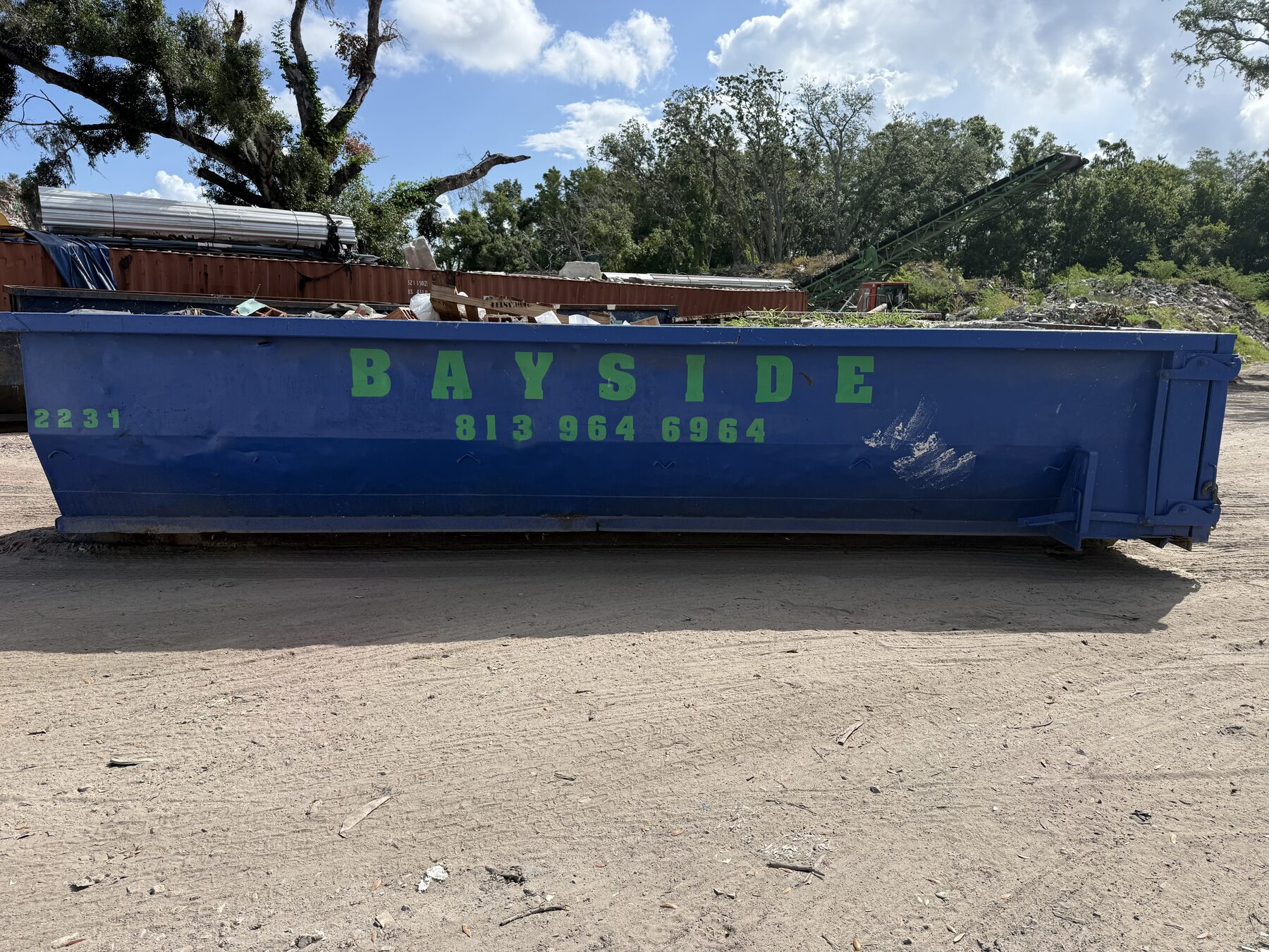 Blue Bayside roll-off dumpster at the Tampa Bay yard